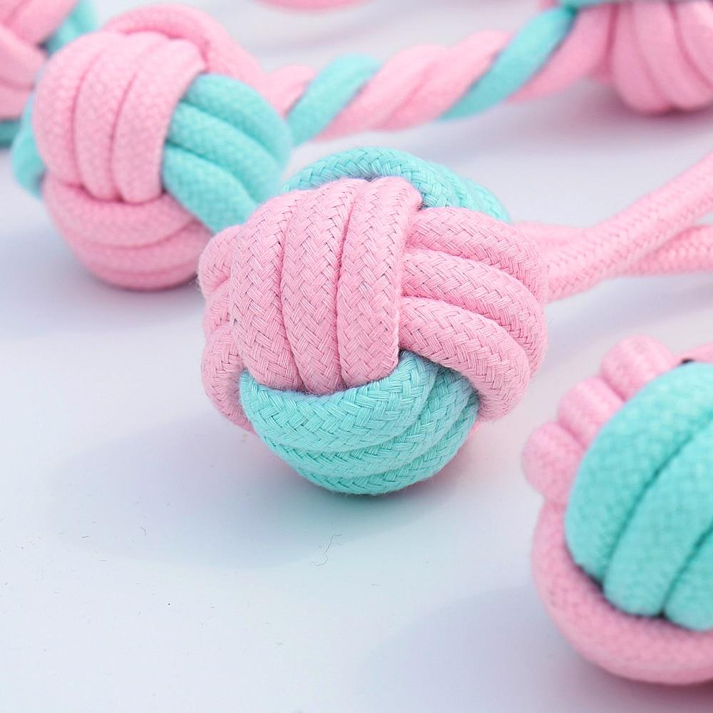 Five colorful cotton rope toys for dogs, designed for chewing and dental cleaning, featuring knots and a vibrant pink color.