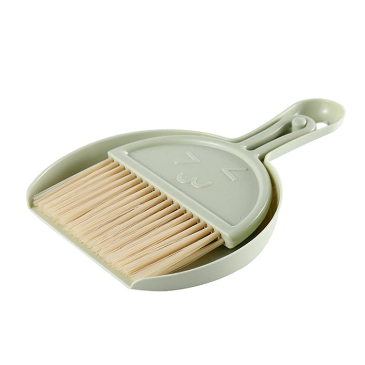 A green mini keyboard cleaning brush set with dustpan, featuring nylon bristles and a compact design for efficient cleaning.