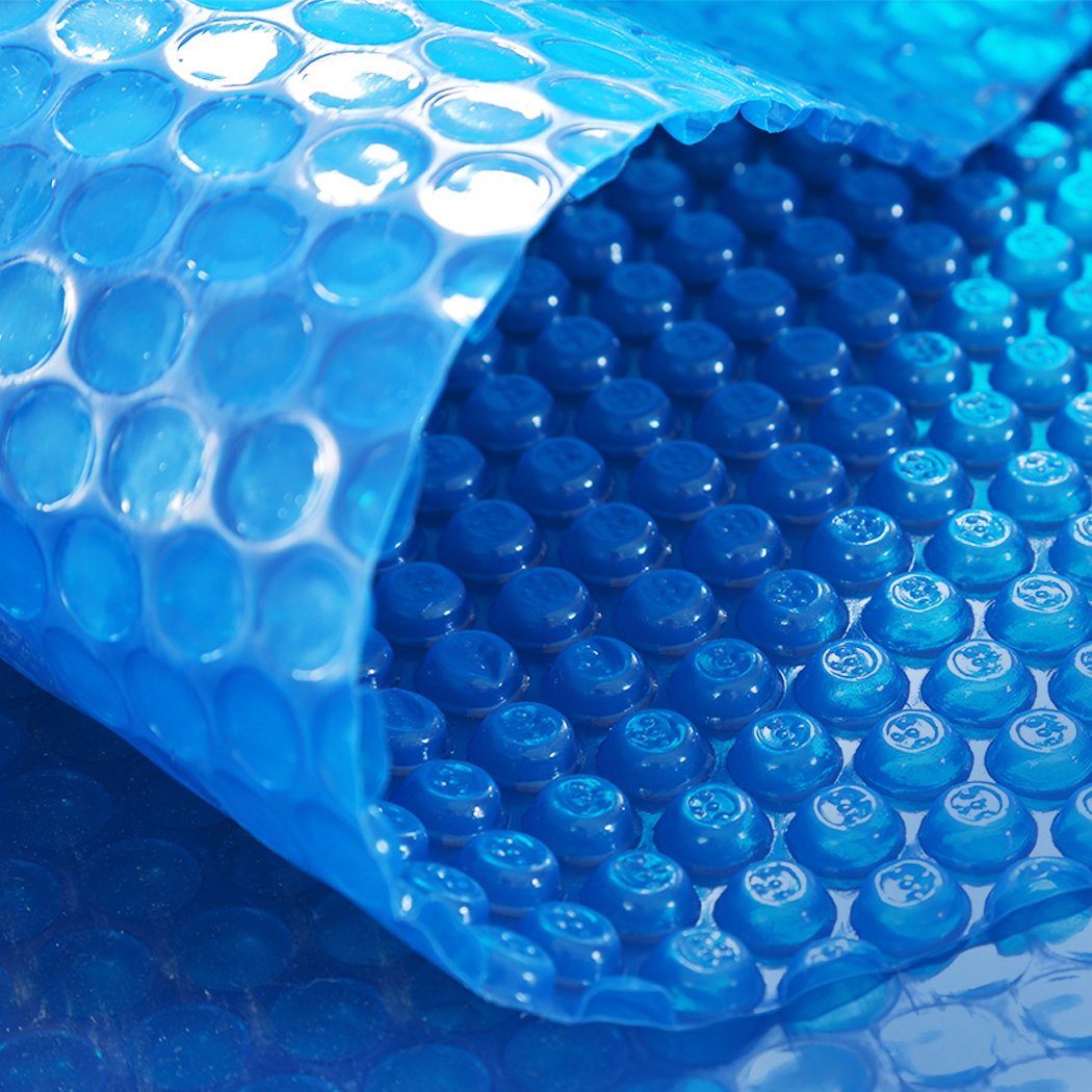 8x4.2M Real 500 Micron Solar Swimming Pool Cover with blue top and silver bottom, designed for warmth and cleanliness.