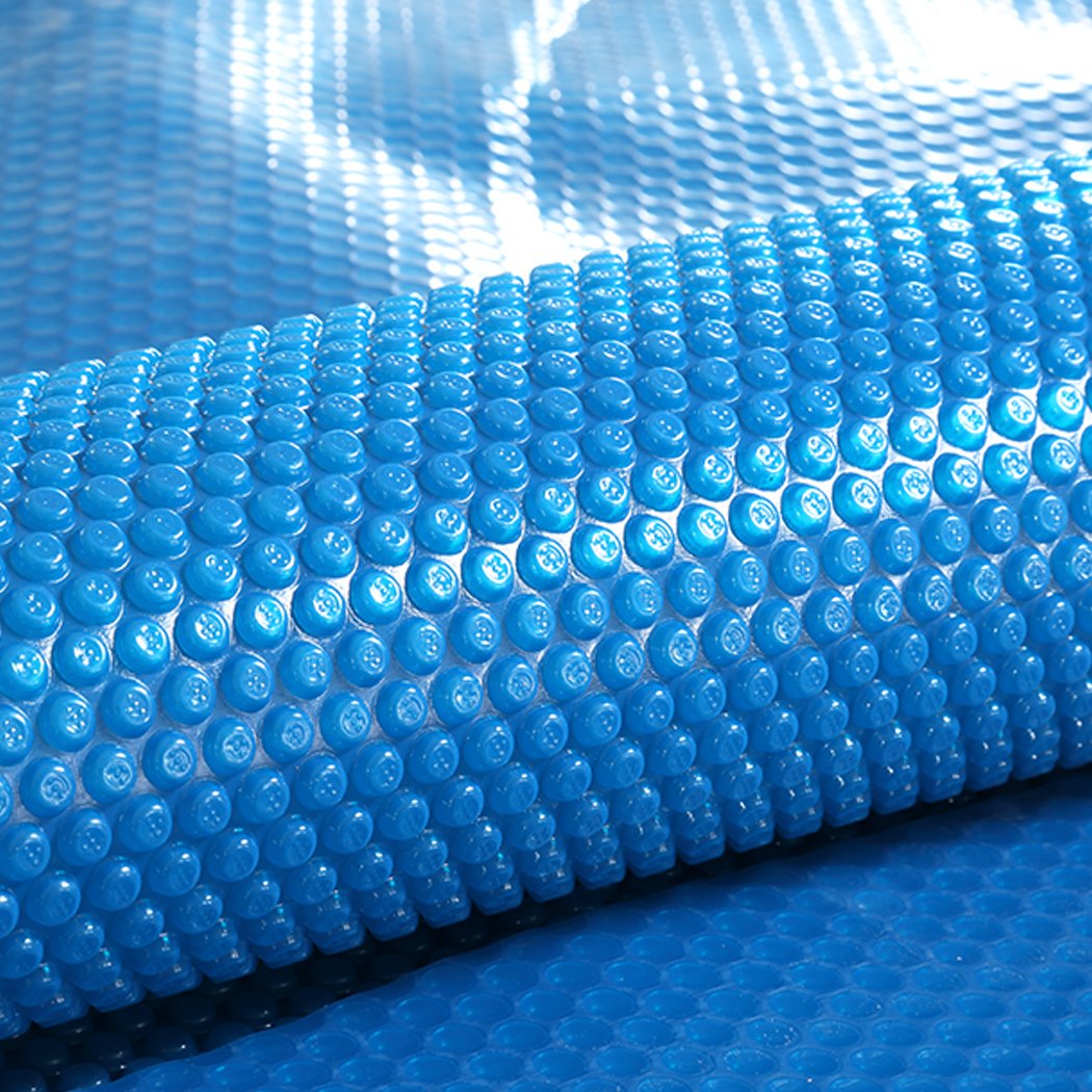 8x4.2M Real 500 Micron Solar Swimming Pool Cover with blue top and silver bottom, designed for durability and efficiency.