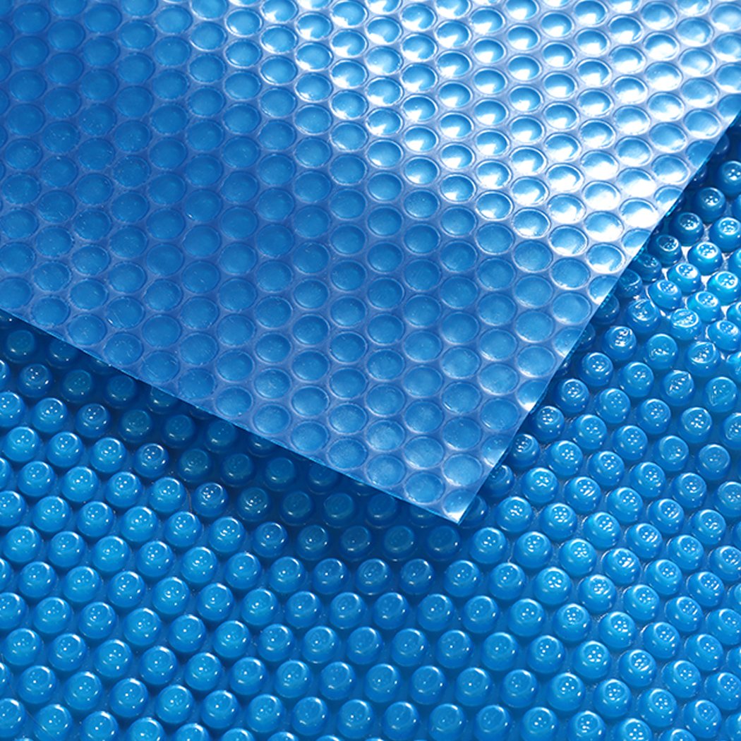8x4.2M Real 500 Micron Solar Swimming Pool Cover with blue top and silver bottom, designed for durability and efficiency.