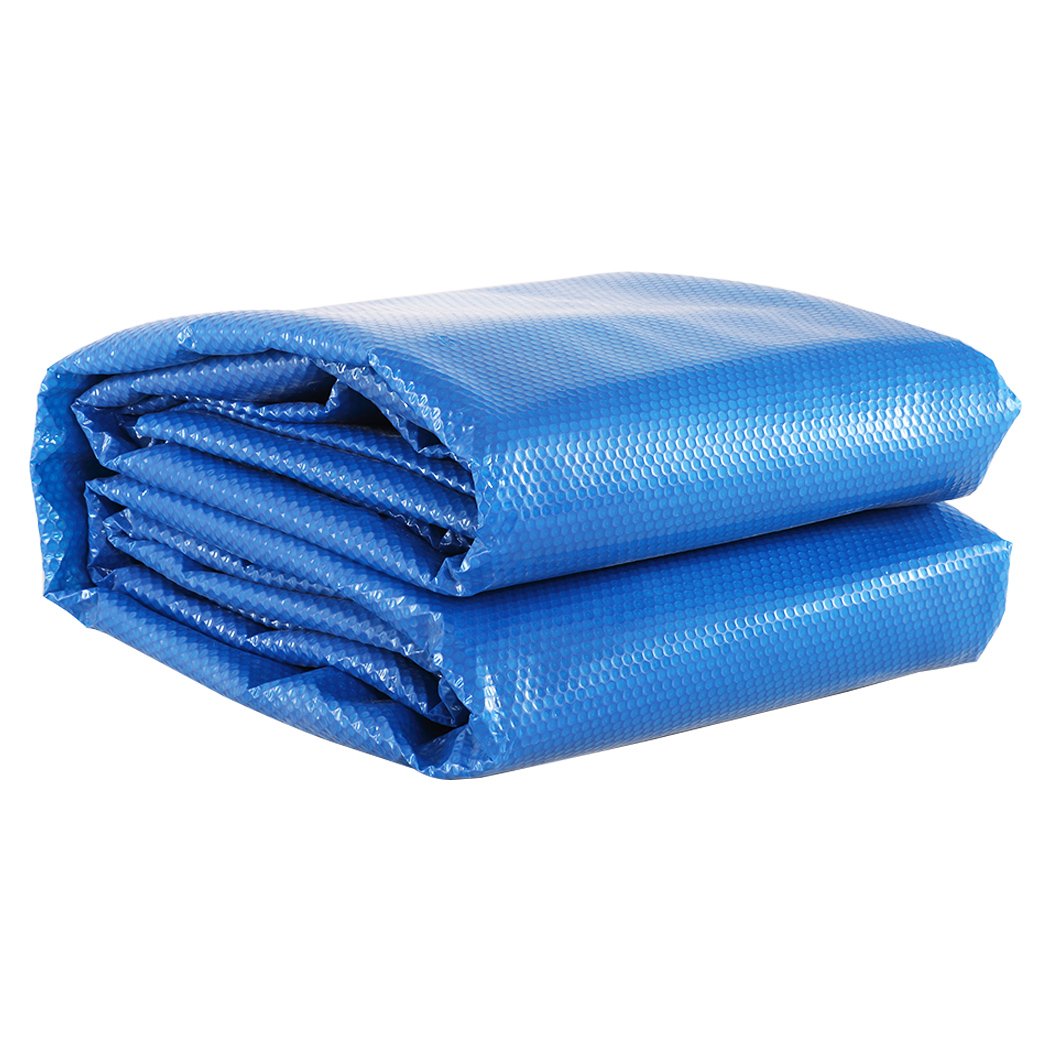 9.5x5M solar swimming pool cover made of 500 micron LDPE material, featuring a blue top and silver bottom, designed for durability and heat retention.