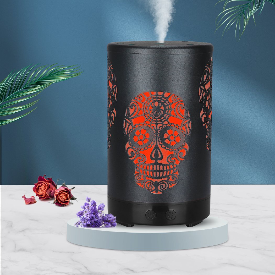 A sleek black Aroma Diffuser with 7-colour LED lights, emitting soothing mist and essential oil aroma, perfect for relaxation and ambiance.