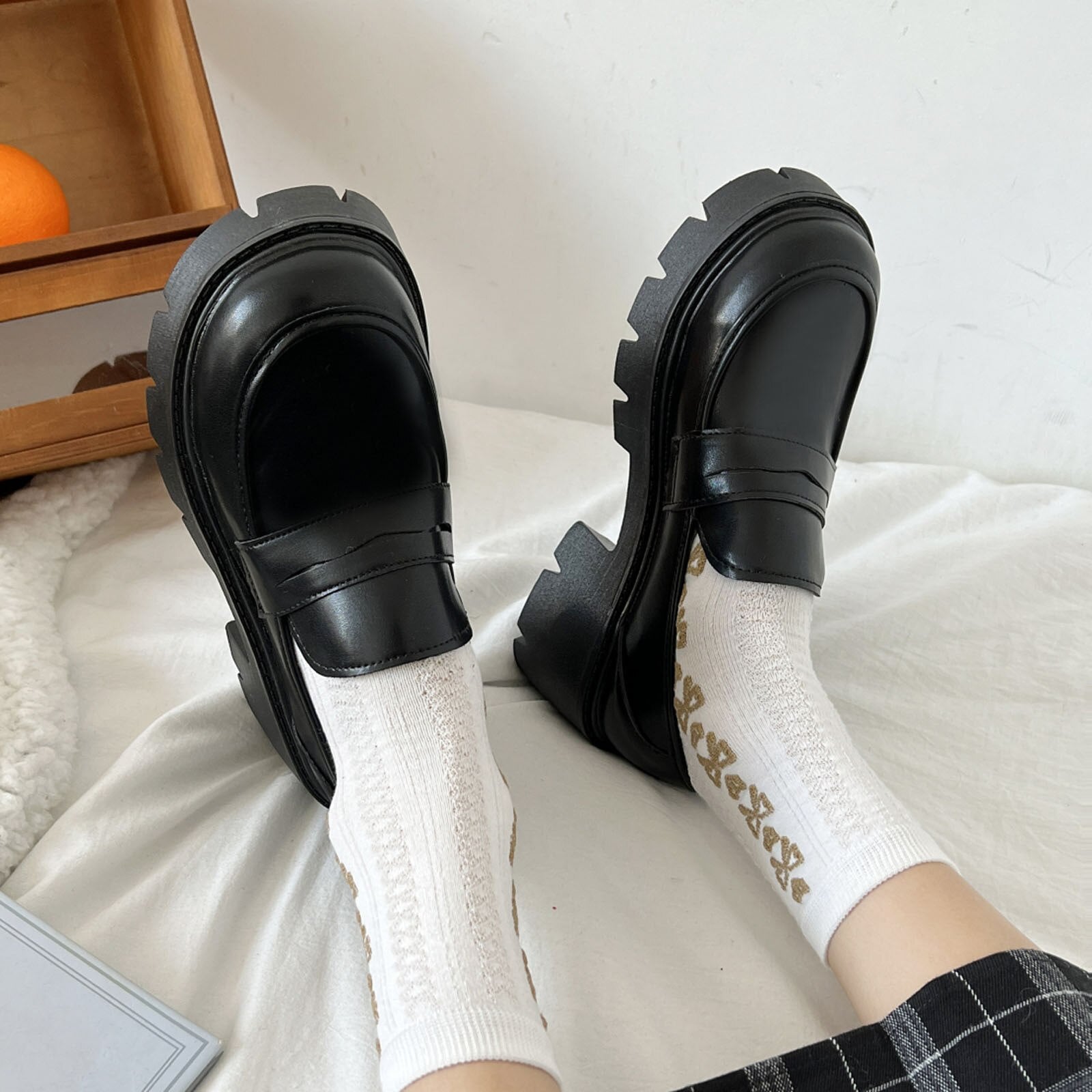 A pair of stylish artificial leather slip-on flat shoes for women, featuring a pointed toe design and a solid color finish, perfect for casual summer wear.