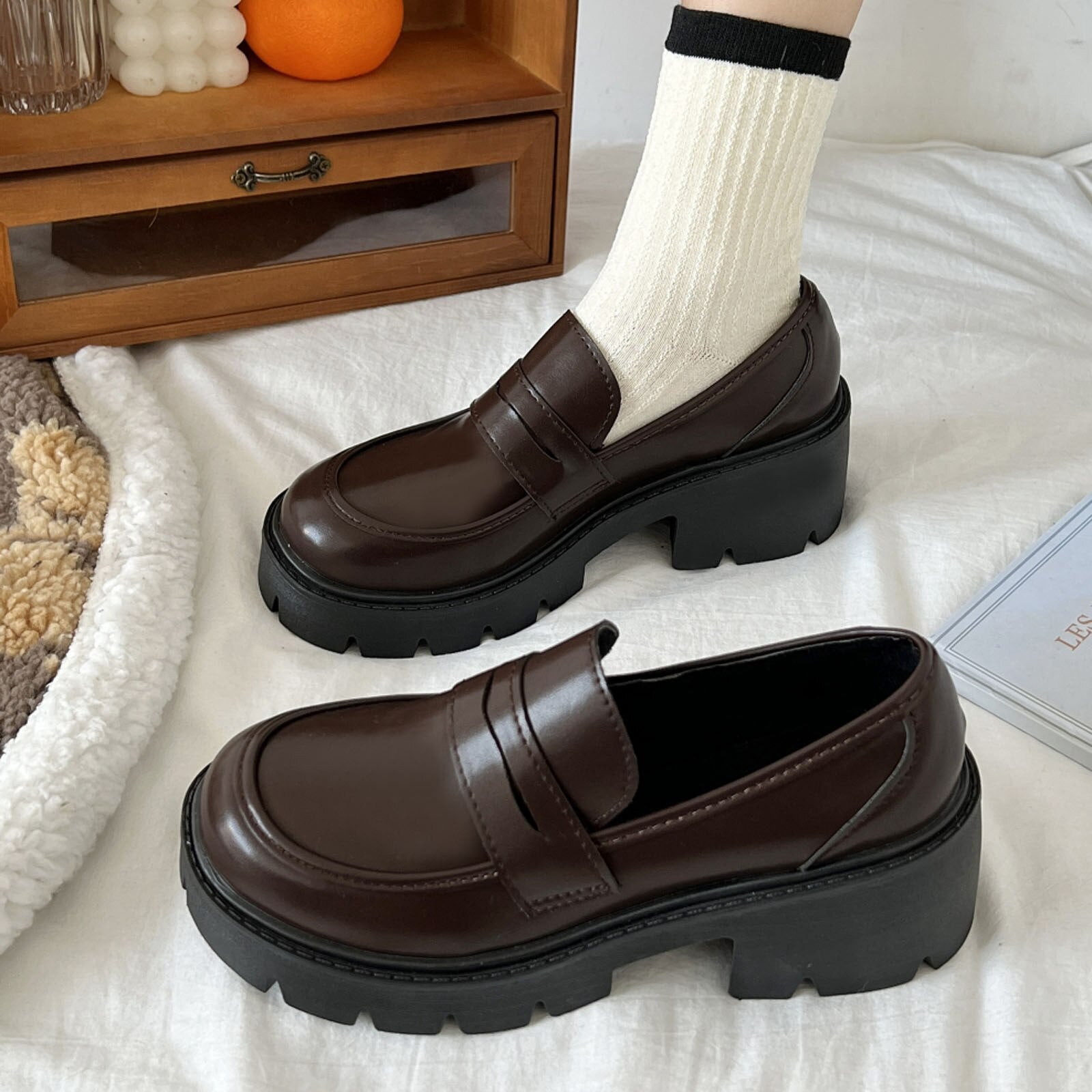 A pair of stylish artificial leather slip-on flat shoes for women, featuring a pointed toe design and a solid color finish, perfect for casual summer wear.