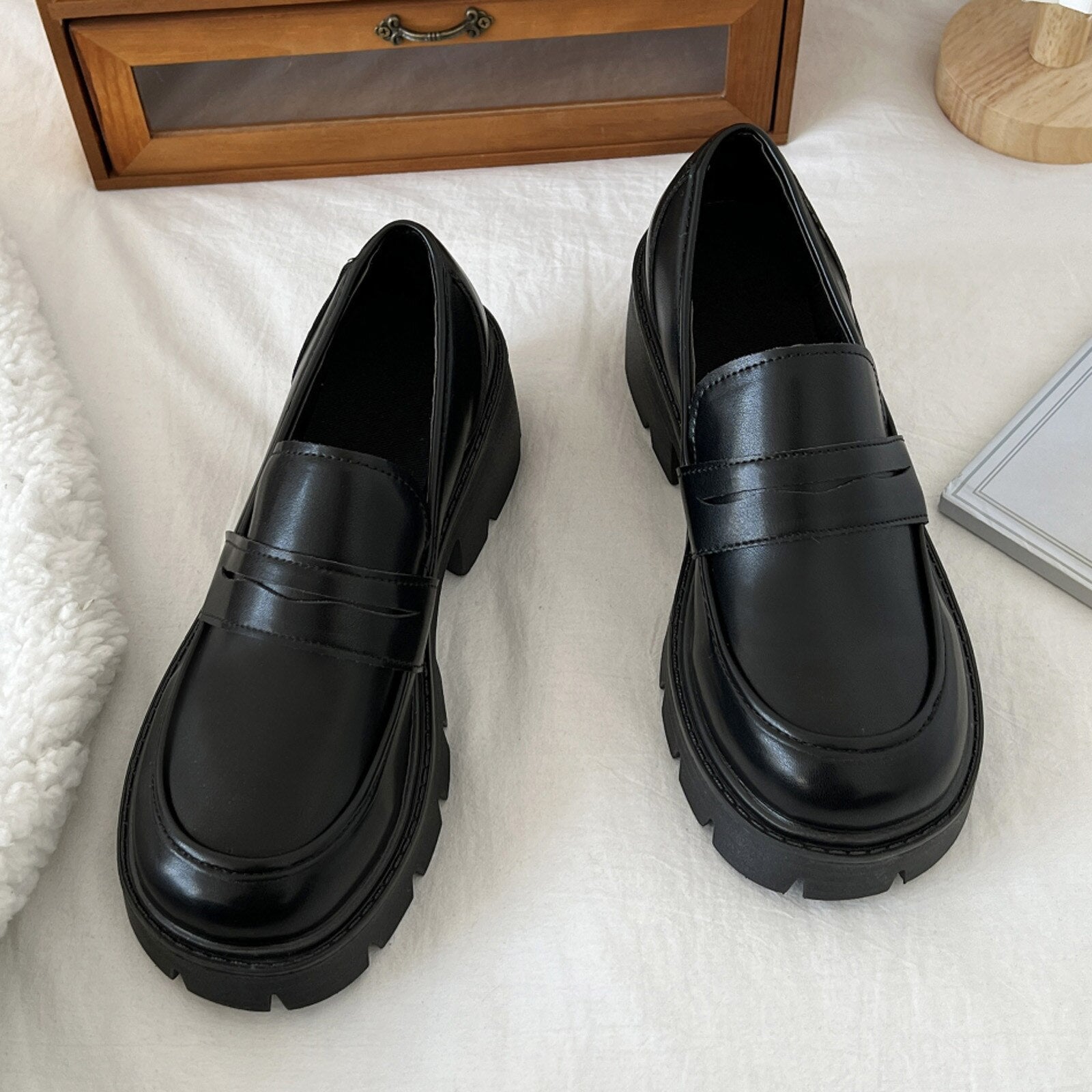A pair of stylish artificial leather slip-on flat shoes for women, featuring a pointed toe design and a solid color finish, perfect for casual summer wear.