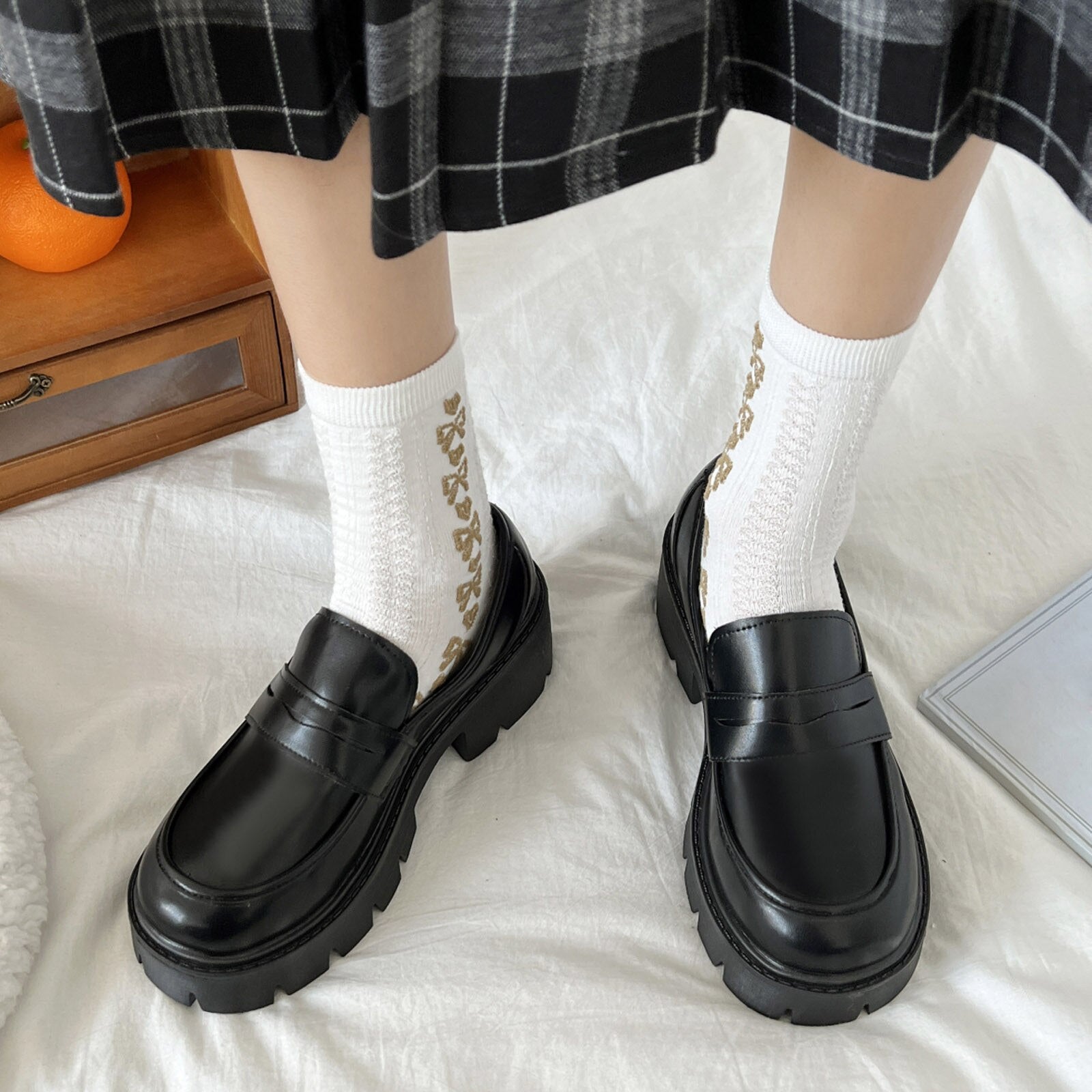 A pair of stylish artificial leather slip-on flat shoes for women, featuring a pointed toe design and a solid color finish, perfect for casual summer wear.