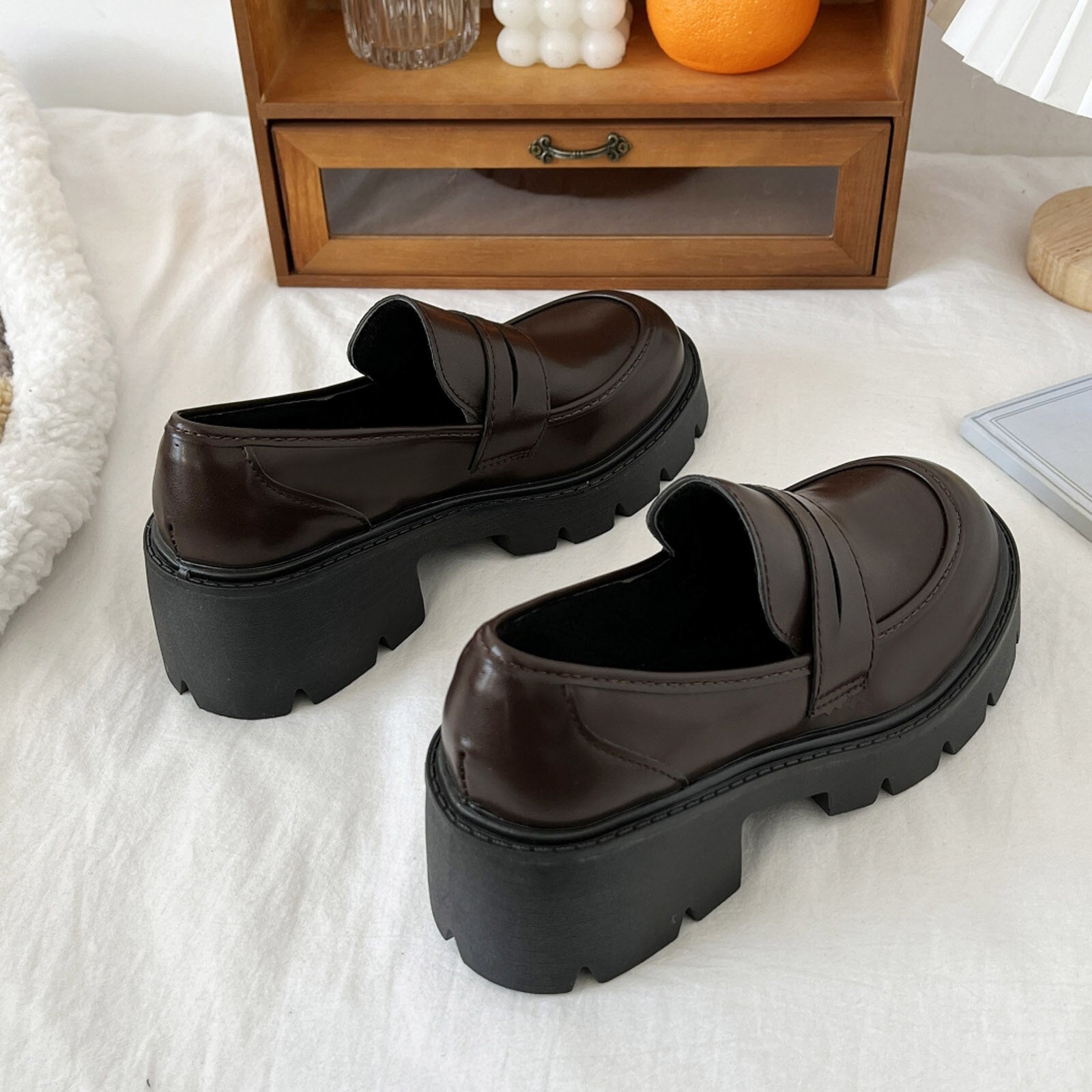 A pair of stylish artificial leather slip-on flat shoes for women, featuring a pointed toe design and a solid color finish, perfect for casual summer wear.