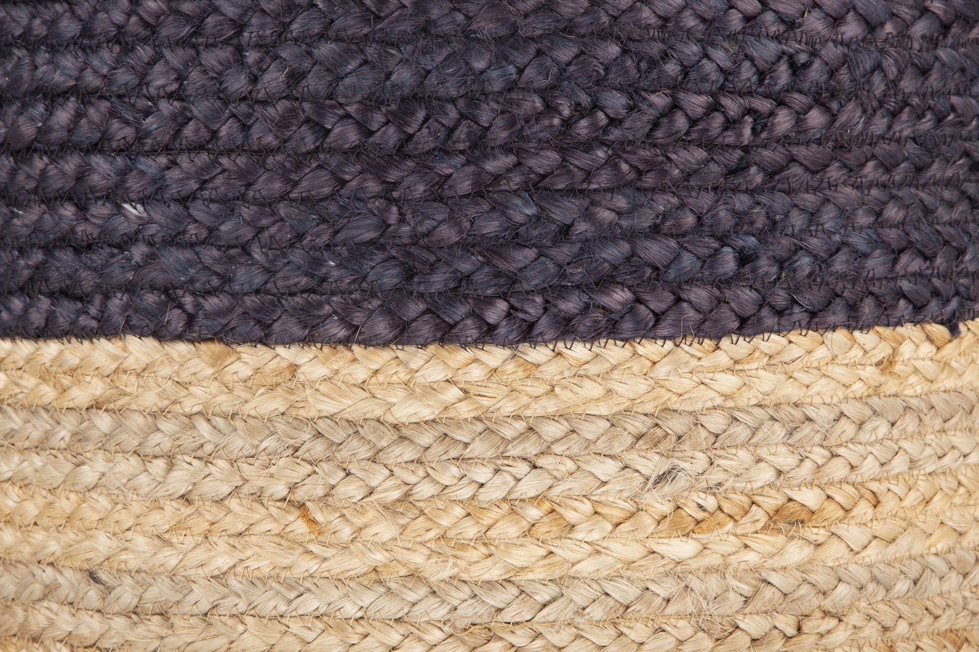 Ava Dual Color Jute Pouf in natural and blue, showcasing its round shape and hand-braided jute texture.