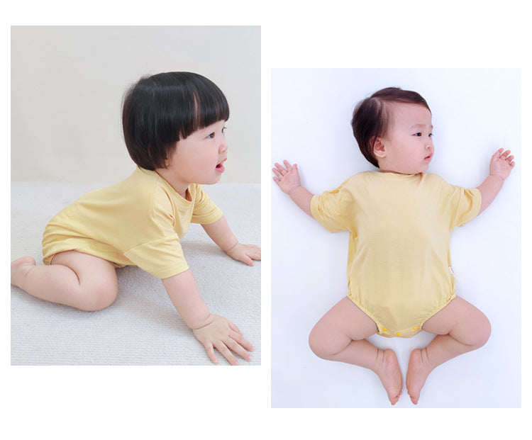 Baby unisex solid color rompers in various colors including pink, blue, green, and yellow, made from soft cotton blend fabric.