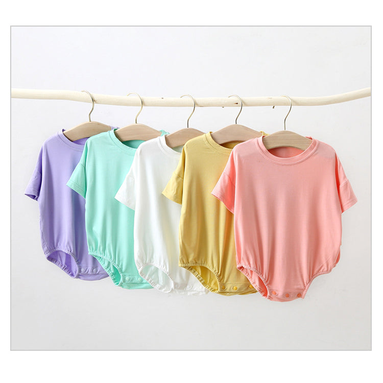 Baby unisex solid color rompers in various colors including pink, blue, green, and yellow, made from soft cotton blend fabric.