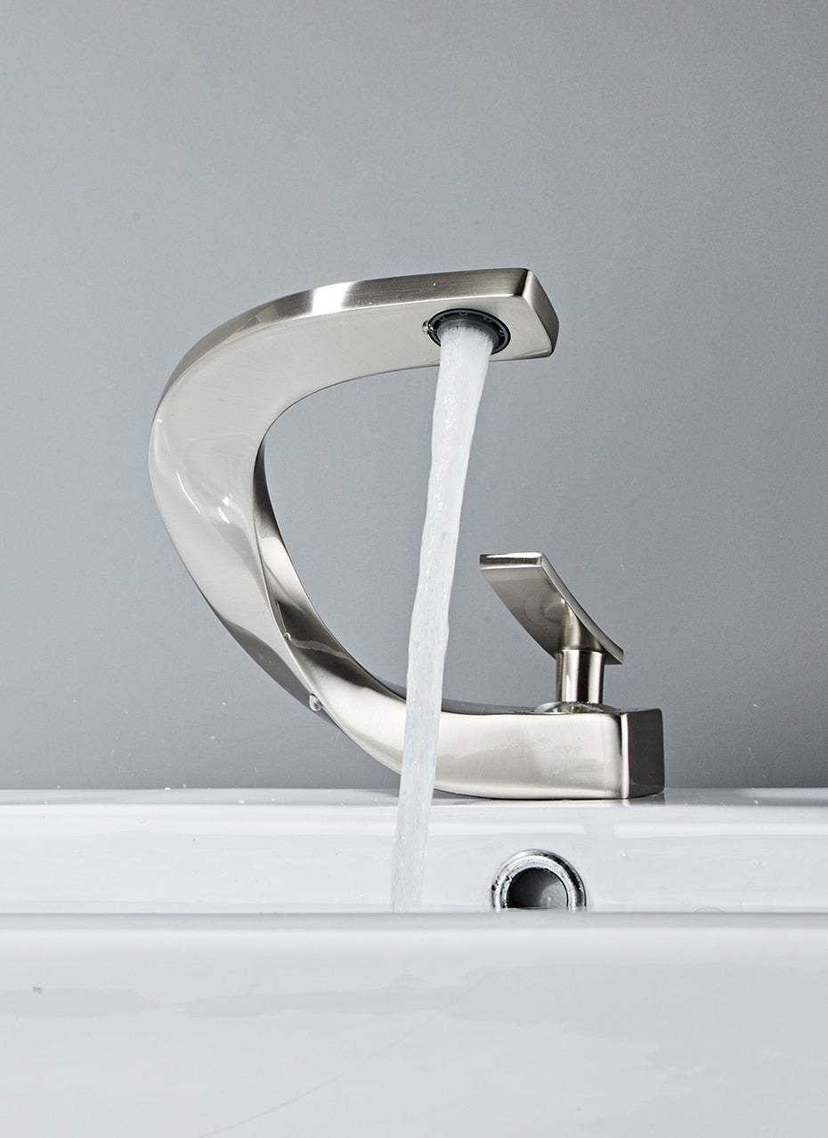 Modern brass basin faucet with single handle and sleek design, available in chrome, brushed nickel, and black finishes.