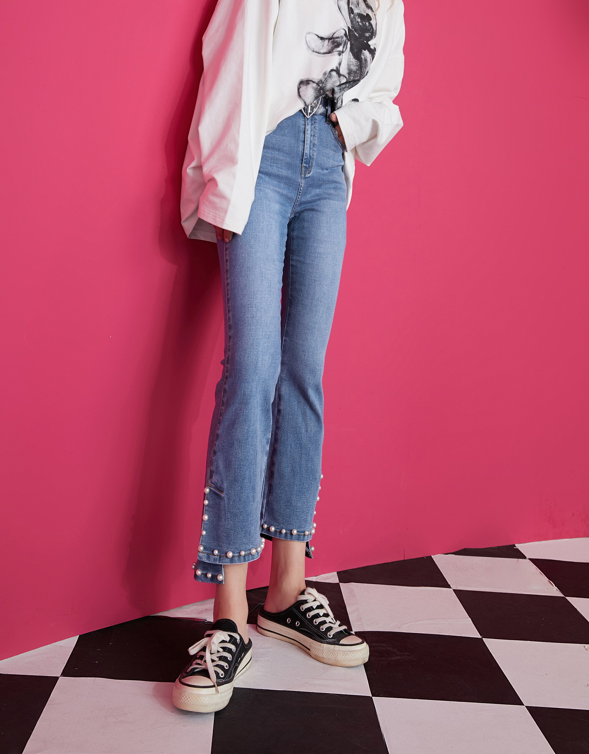 A pair of blue solid high waist washed casual flare jeans for women, featuring a minimalist design and ankle-length cut.