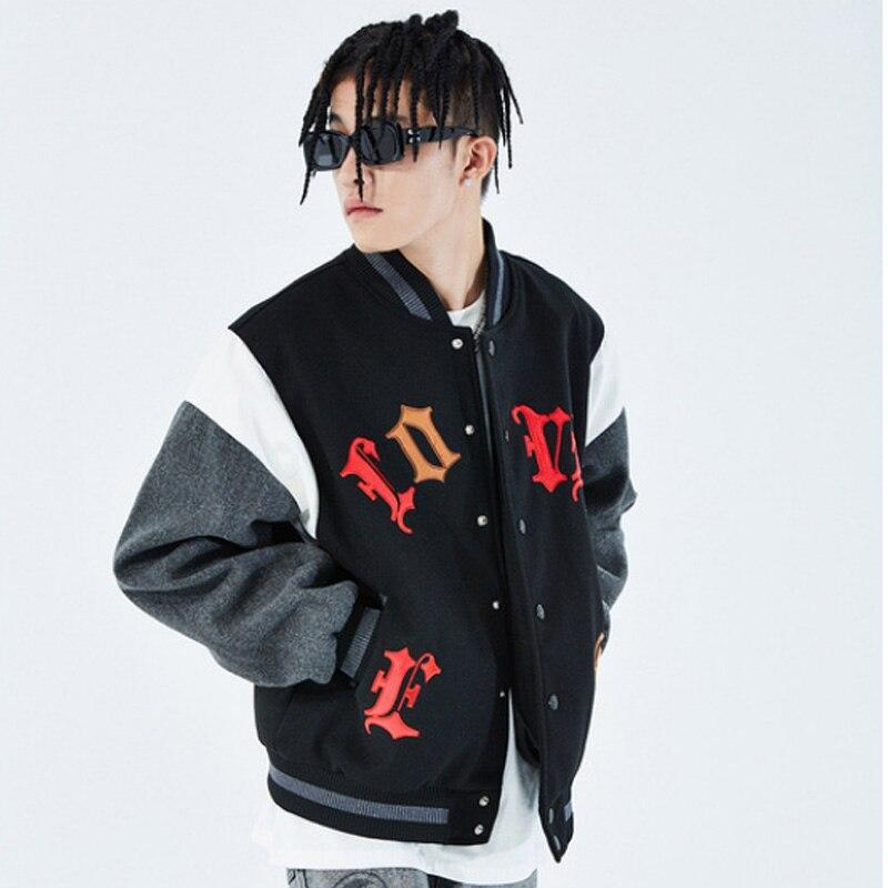 Men's bomber jacket featuring heart-shaped patch and letter embroidery, stylish patchwork design for autumn and winter wear.