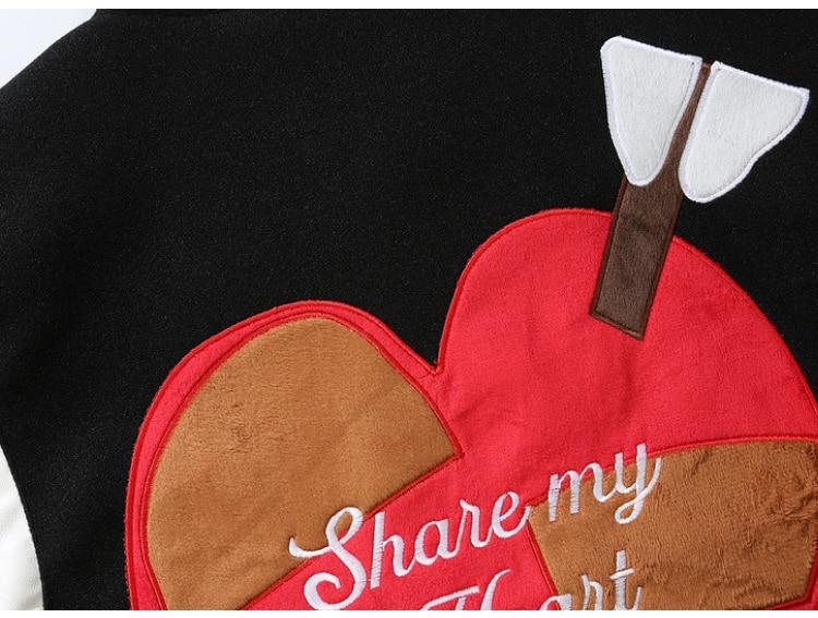 Men's bomber jacket featuring heart-shaped patch and letter embroidery, stylish patchwork design for autumn and winter wear.