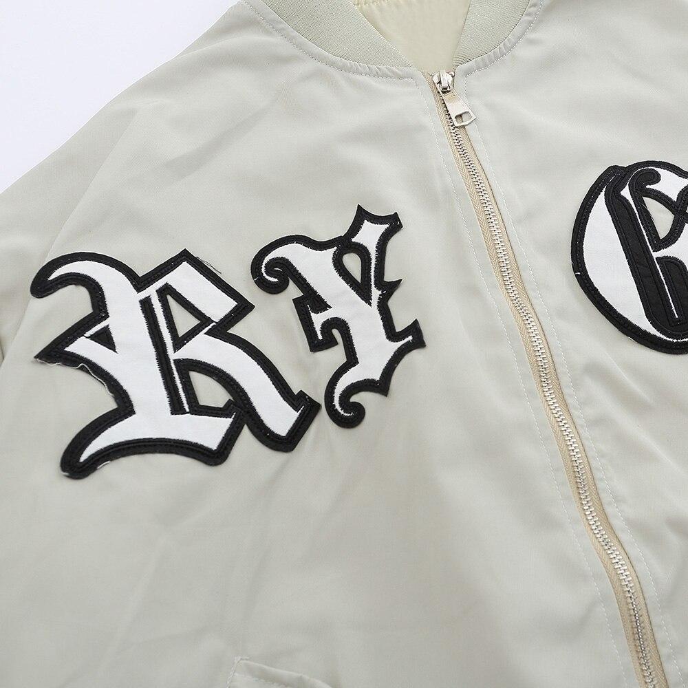 Men's bomber jacket featuring punk letter patches and pleated cargo design, ideal for autumn wear.