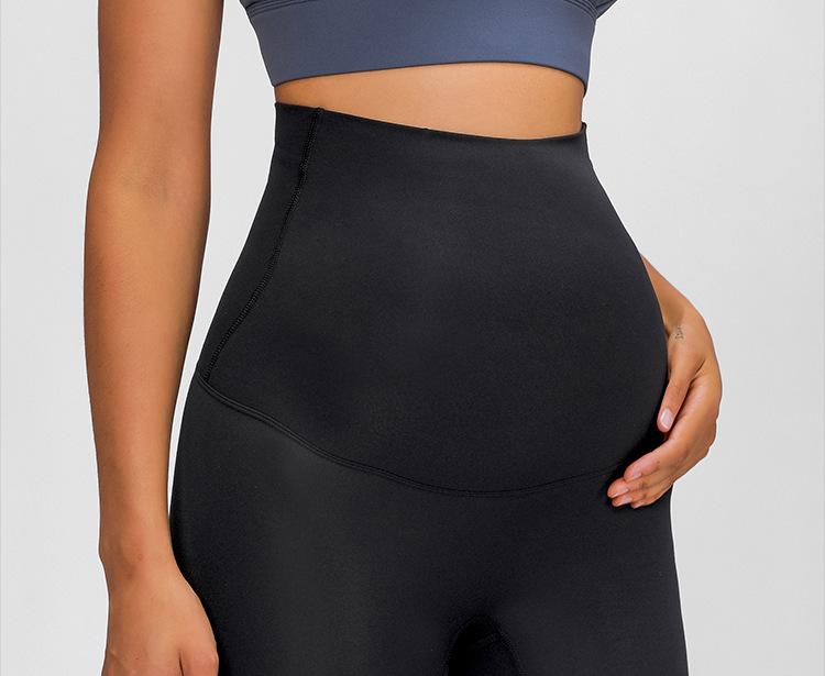 A pair of buttery-soft high rise yoga pants designed for pregnant women, showcasing their stretchy fabric and elastic waist.