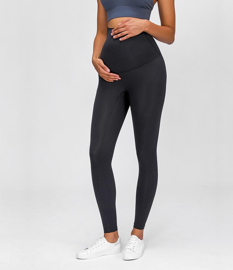 A pair of buttery-soft high rise yoga pants designed for pregnant women, showcasing their stretchy fabric and elastic waist.