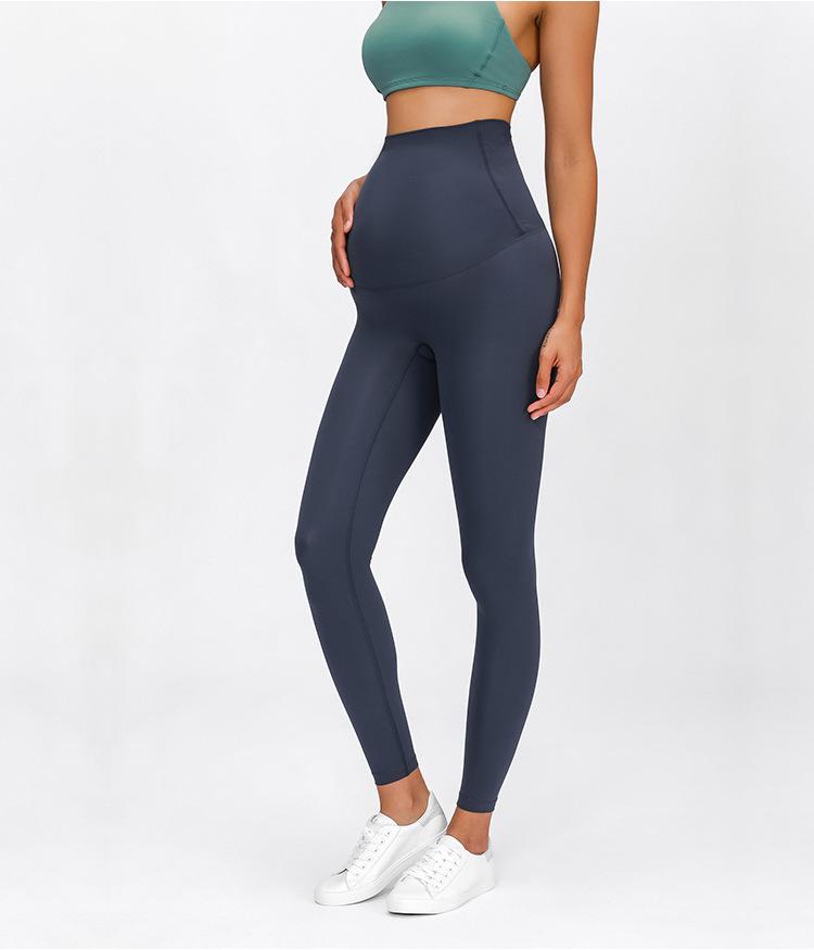 A pair of buttery-soft high rise yoga pants designed for pregnant women, showcasing their stretchy fabric and elastic waist.