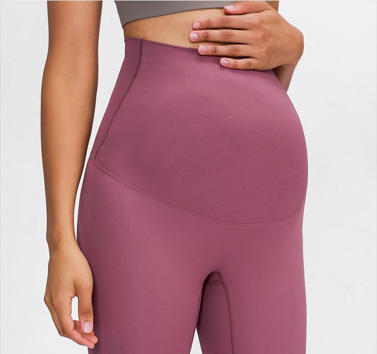 A pair of buttery-soft high rise yoga pants designed for pregnant women, showcasing their stretchy fabric and elastic waist.