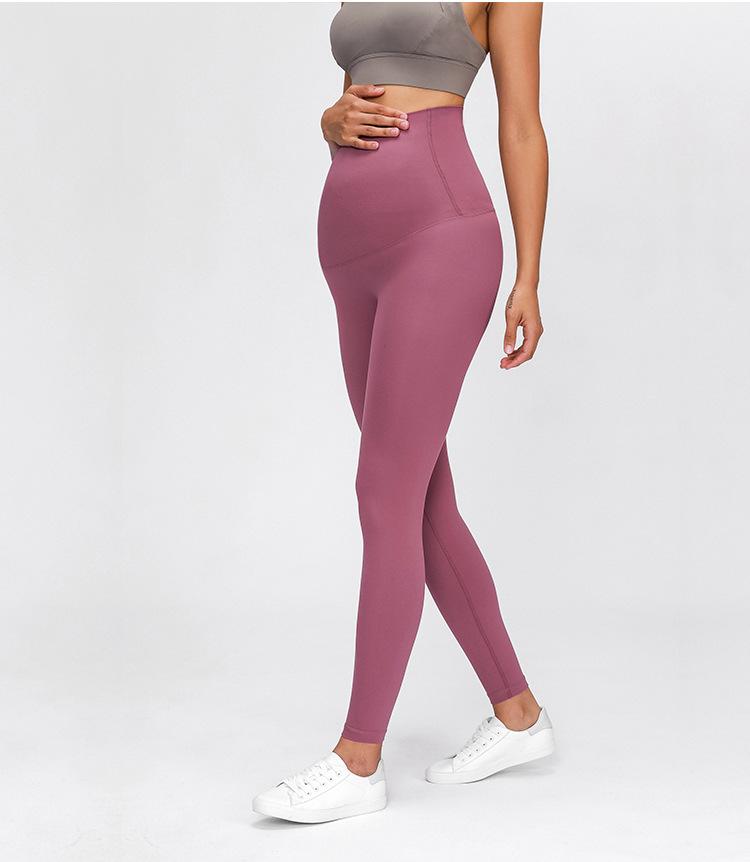 A pair of buttery-soft high rise yoga pants designed for pregnant women, showcasing their stretchy fabric and elastic waist.