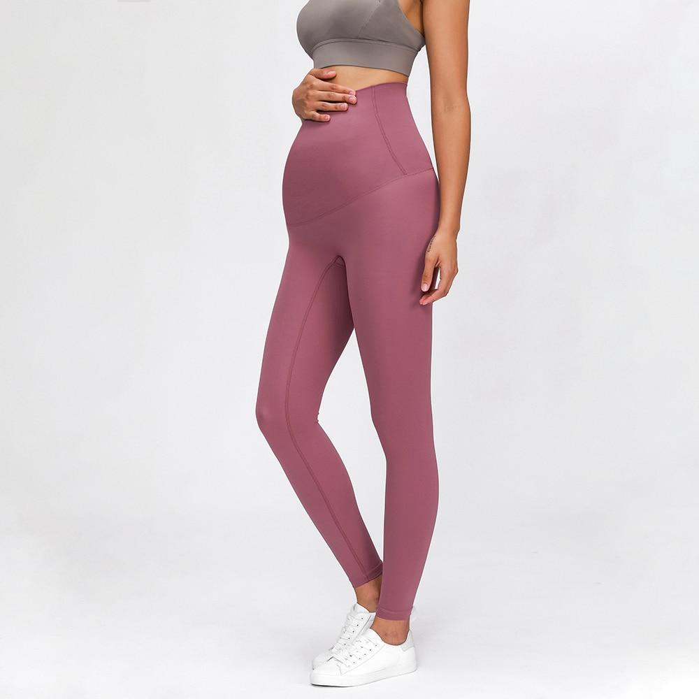 A pair of buttery-soft high rise yoga pants designed for pregnant women, showcasing their stretchy fabric and elastic waist.