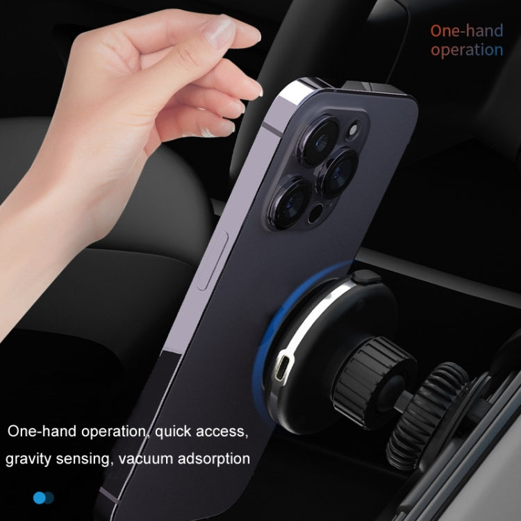 Car Electric Vacuum Suction Cup Mobile Phone Holder mounted on a dashboard, securely holding a smartphone with wireless charging feature.
