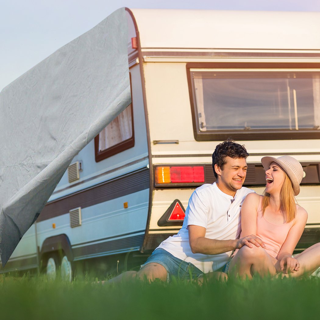 Heavy-duty caravan cover in grey, showcasing 4-layer construction and adjustable straps for secure fit.