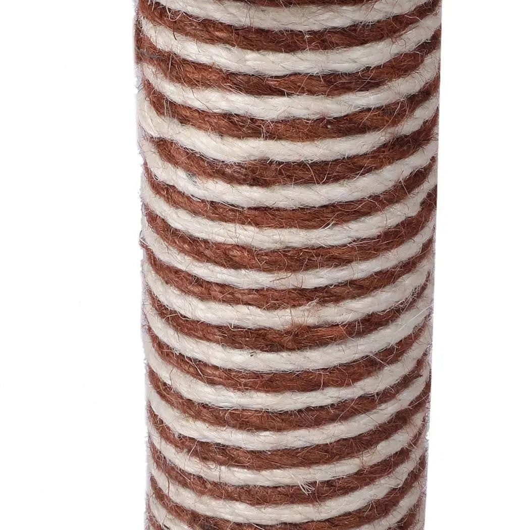 A beige multi-level cat tree tower with plush covering, featuring a sisal scratching post and hanging toys for playful cats.