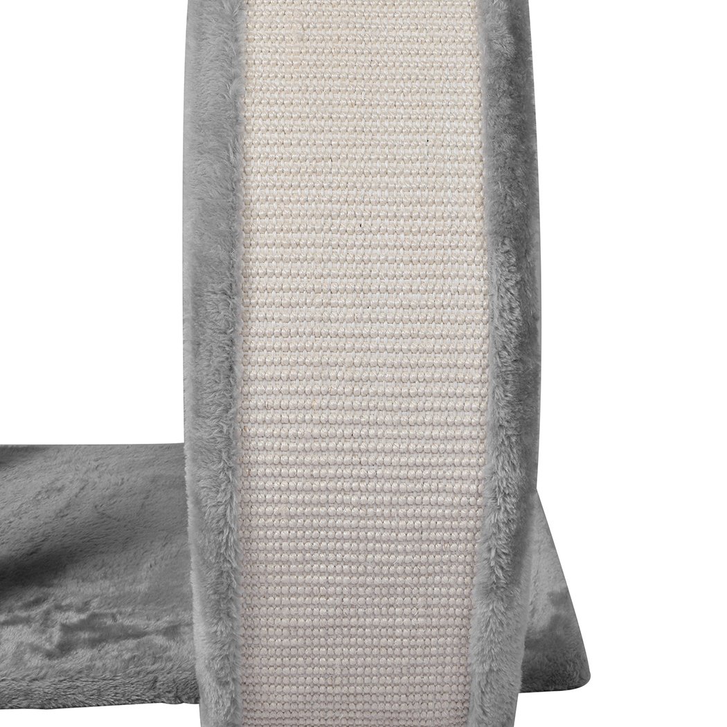 A grey multi-level cat tree tower with plush covering, featuring a scratching post wrapped in sisal and hanging toys for playful cats.