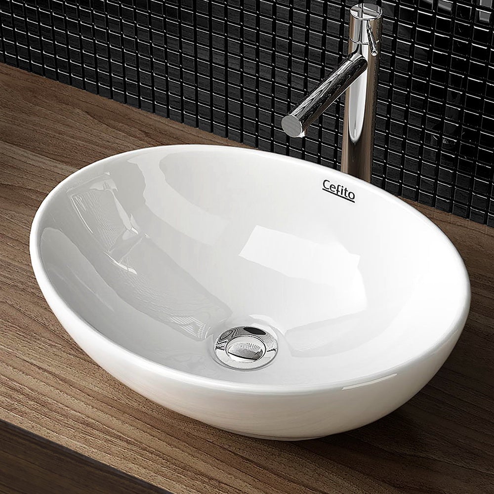 Cefito Ceramic Oval Sink Bowl in White, showcasing its elegant design and high gloss finish.