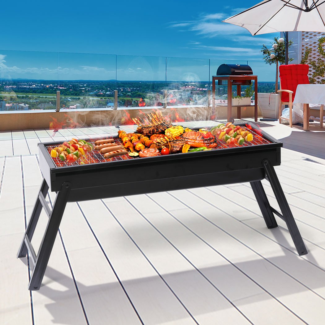Portable Charcoal BBQ Grill with chrome steel top and air vents, perfect for outdoor cooking and camping.