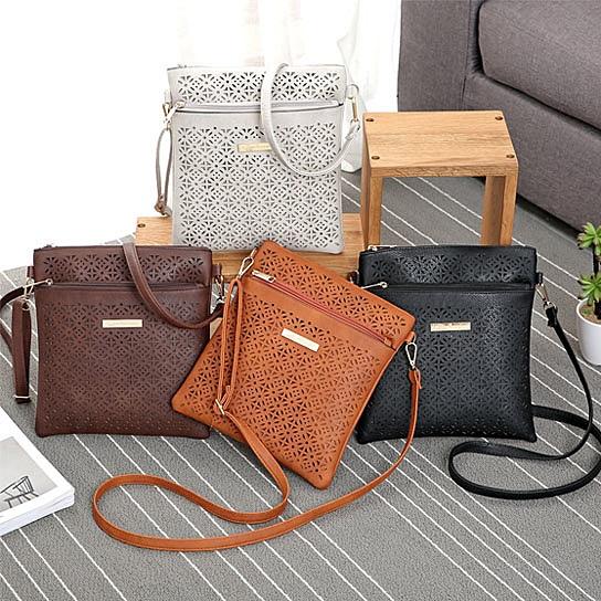 Classic Square Crossbody Bag featuring a floral cutout design, zippered pockets, and adjustable strap, made from durable vegan leather.