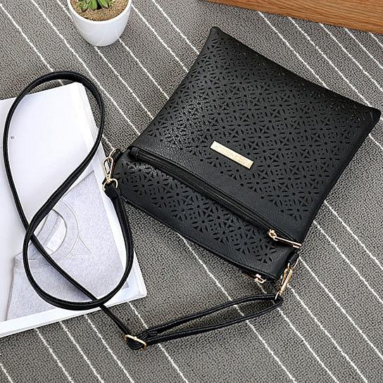 Classic Square Crossbody Bag featuring a floral cutout design, zippered pockets, and adjustable strap, made from durable vegan leather.