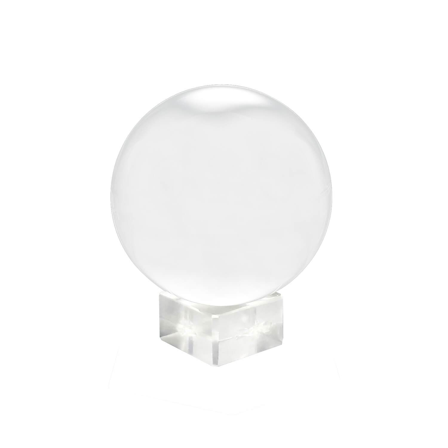 Clear Glass Healing Crystal Ball Sphere on a reflective surface, showcasing its transparent design and perfect for photography props.