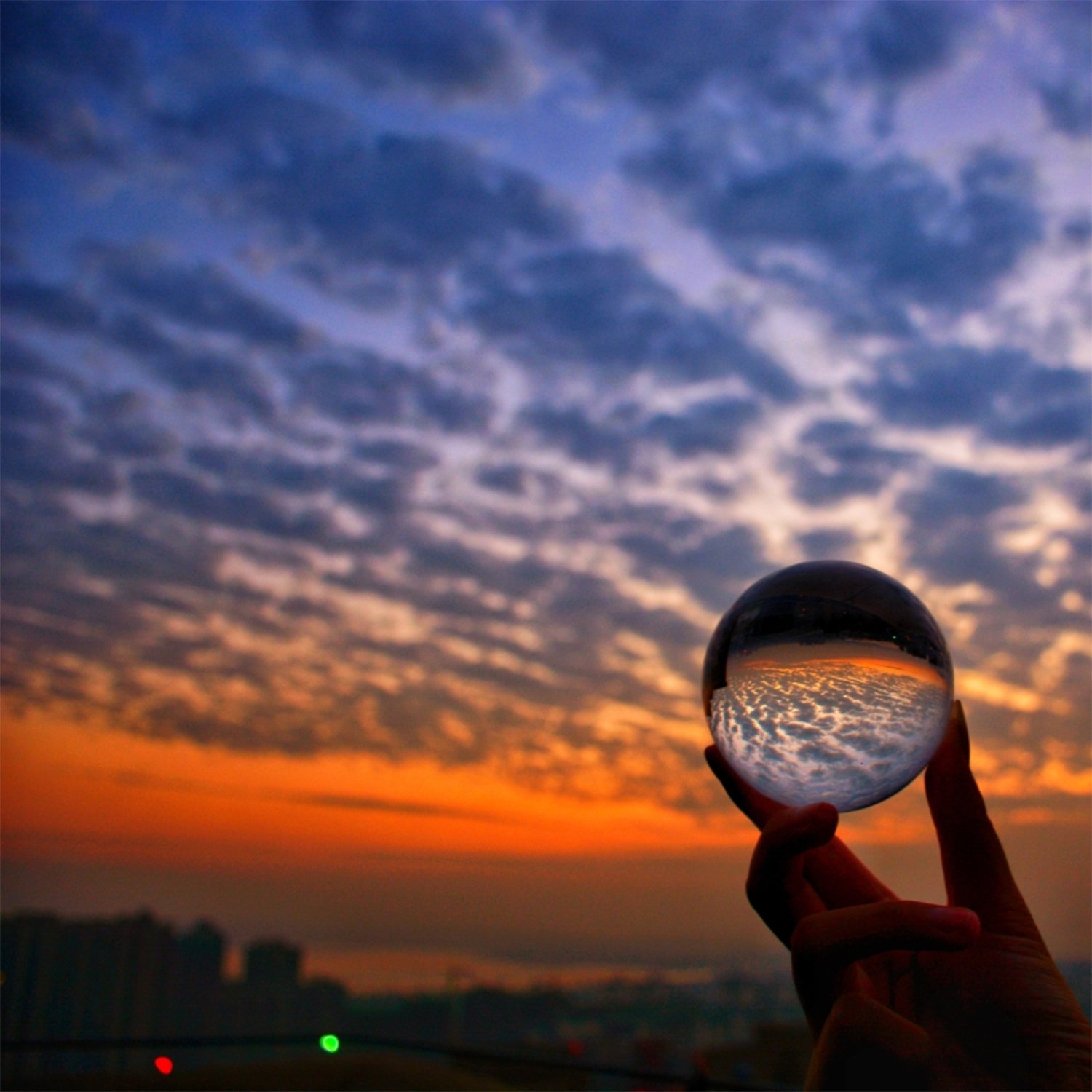 Clear Glass Healing Crystal Ball Sphere on a reflective surface, showcasing its transparent design and perfect for photography props.