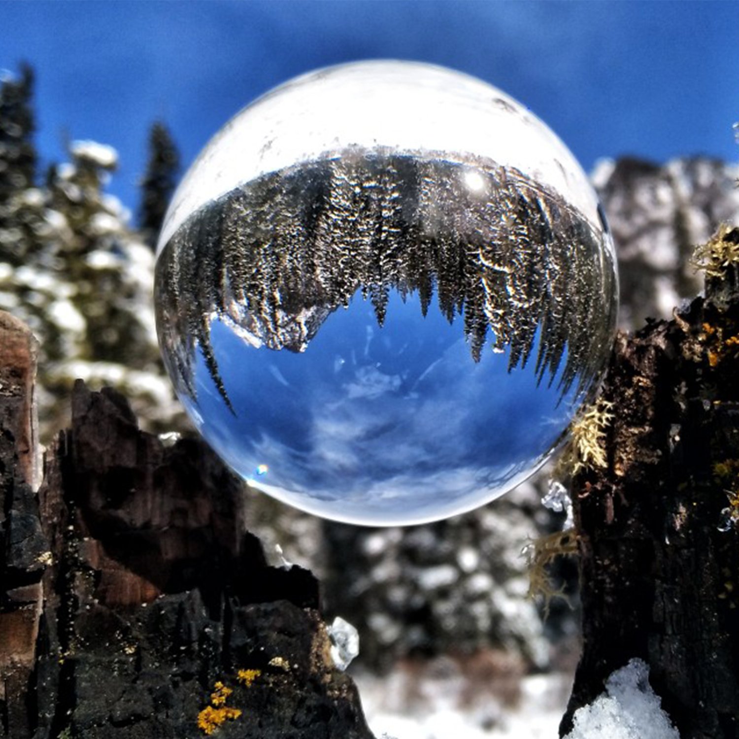 Clear Glass Healing Crystal Ball Sphere on a reflective surface, showcasing its transparent design and perfect for photography props.