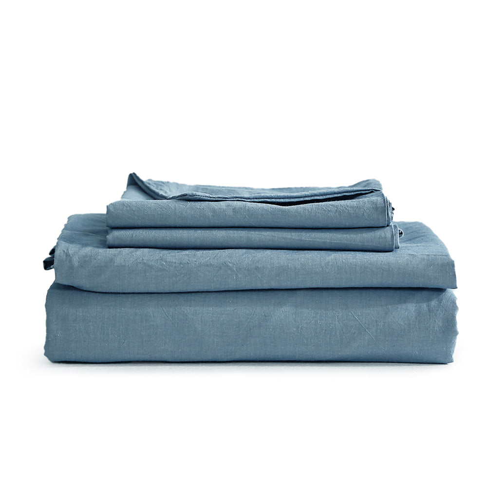 Cosy Club Sheet Set in blue, featuring a flat sheet, fitted sheet, and pillowcase made from 100% washed cotton, showcasing a soft and breathable texture.
