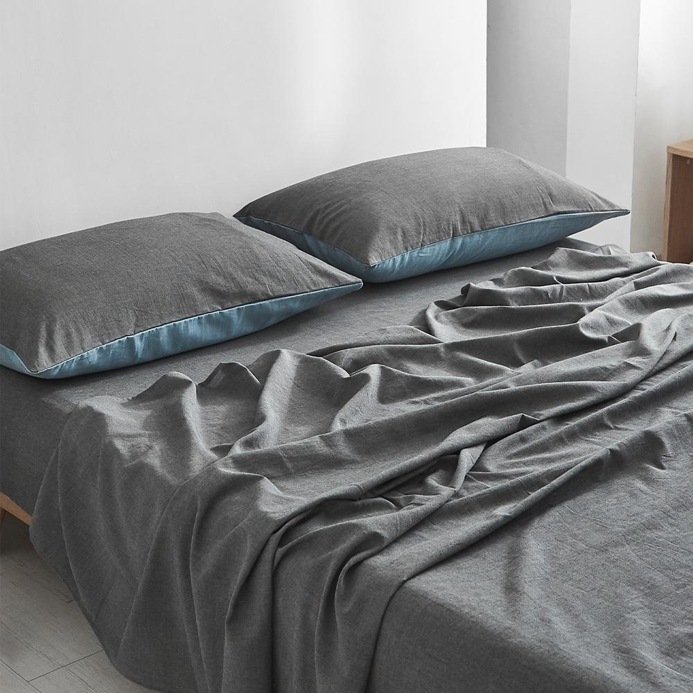 Cosy Club Dark Blue Cotton Sheet Set displayed on a neatly made bed, showcasing its soft texture and elegant two-tone design.