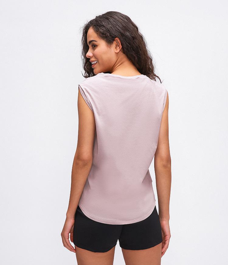 Women wearing Cotton Fitness Workout Gym Tank Tops, showcasing the sleeveless design and hip-length fit in a gym setting.