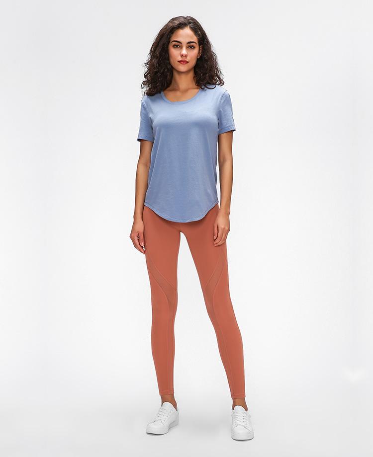 A stylish Cotton Yoga Exercise Workout T-shirt for women, featuring short sleeves and a hip-length design, perfect for workouts and casual wear.