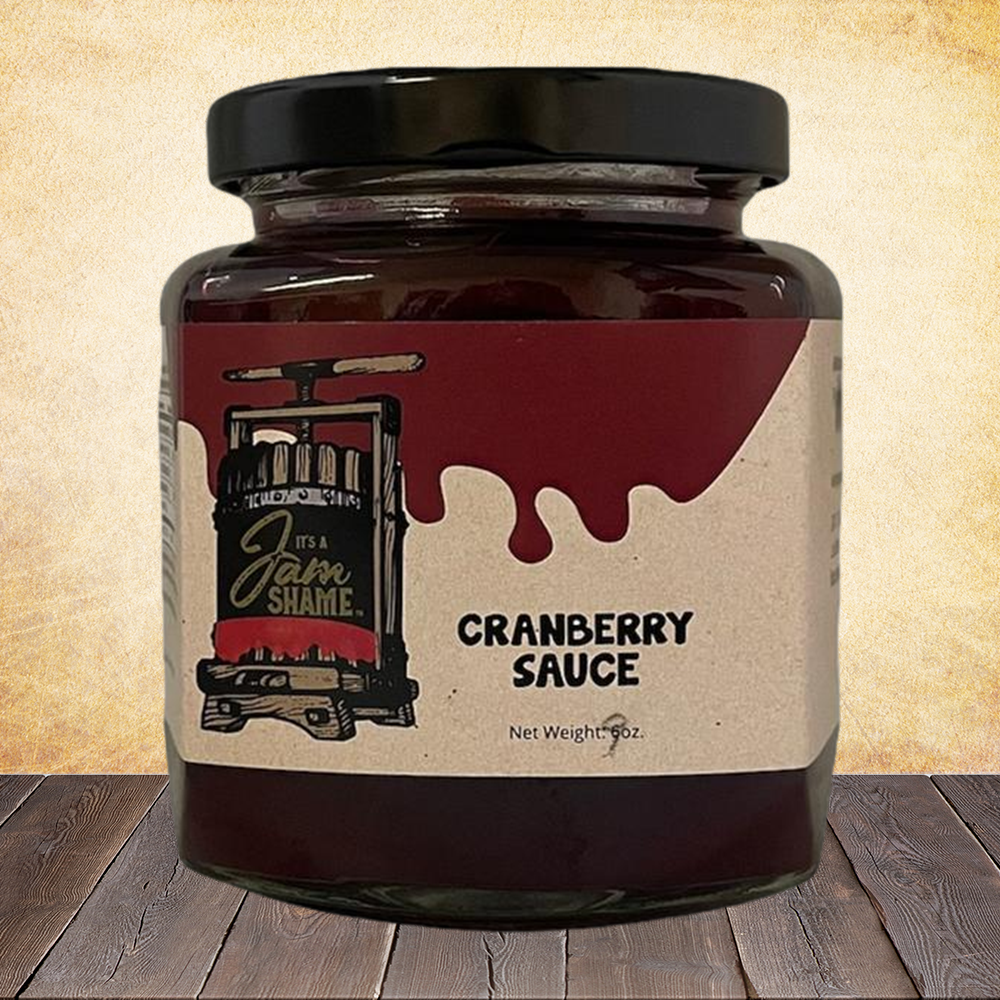 A jar of vibrant cranberry sauce, showcasing its rich red color, perfect for festive meals and sandwiches.