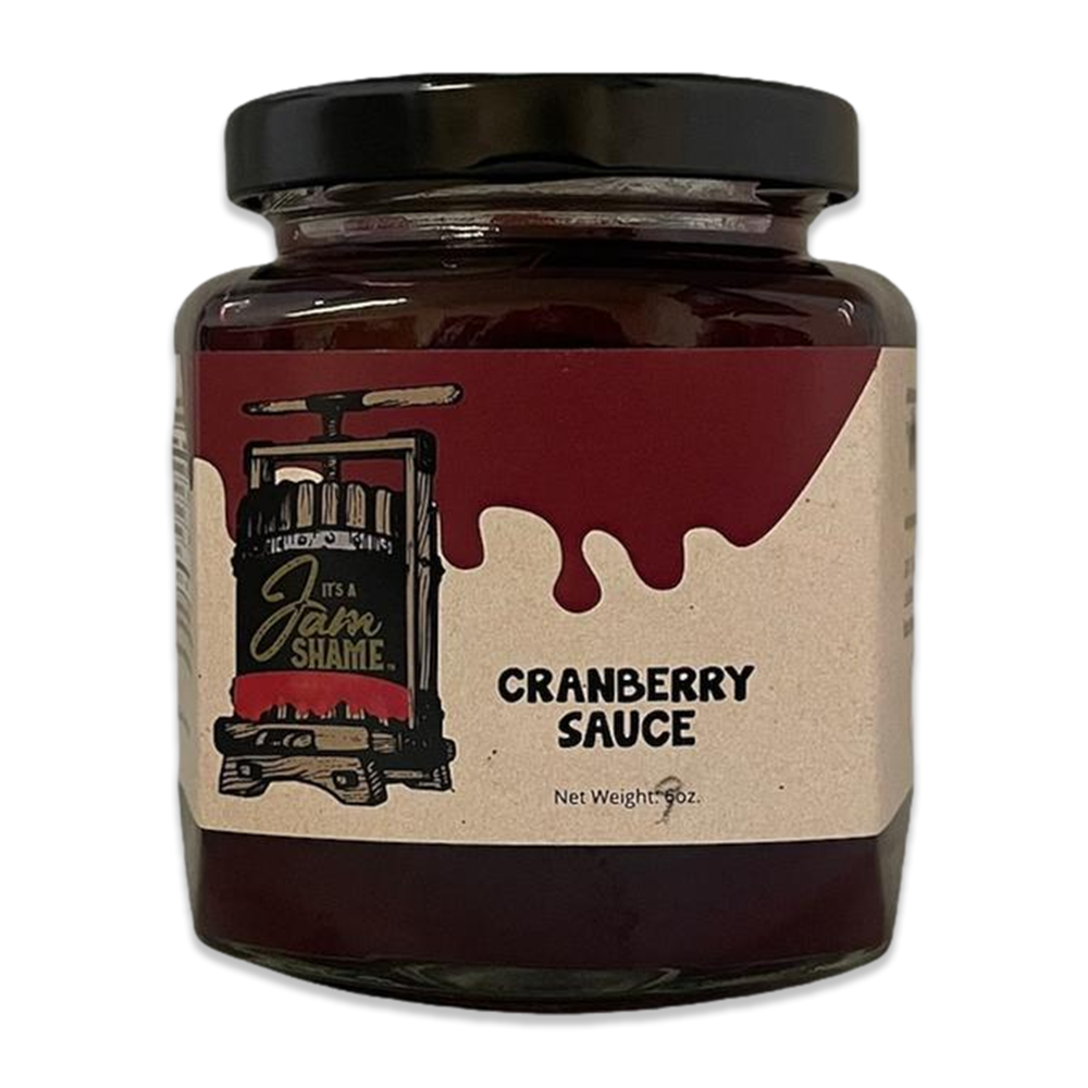 A jar of vibrant cranberry sauce, showcasing its rich red color, perfect for festive meals and sandwiches.