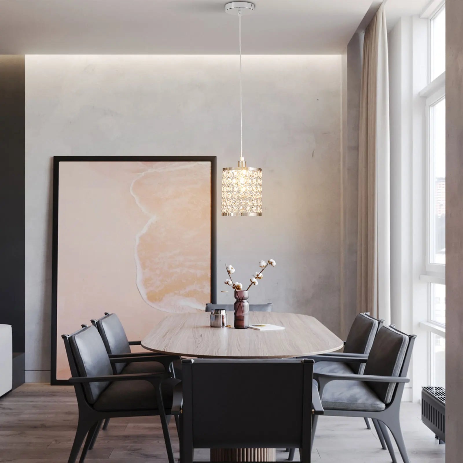 Elegant crystal pendant light with adjustable cord, perfect for modern kitchen islands.