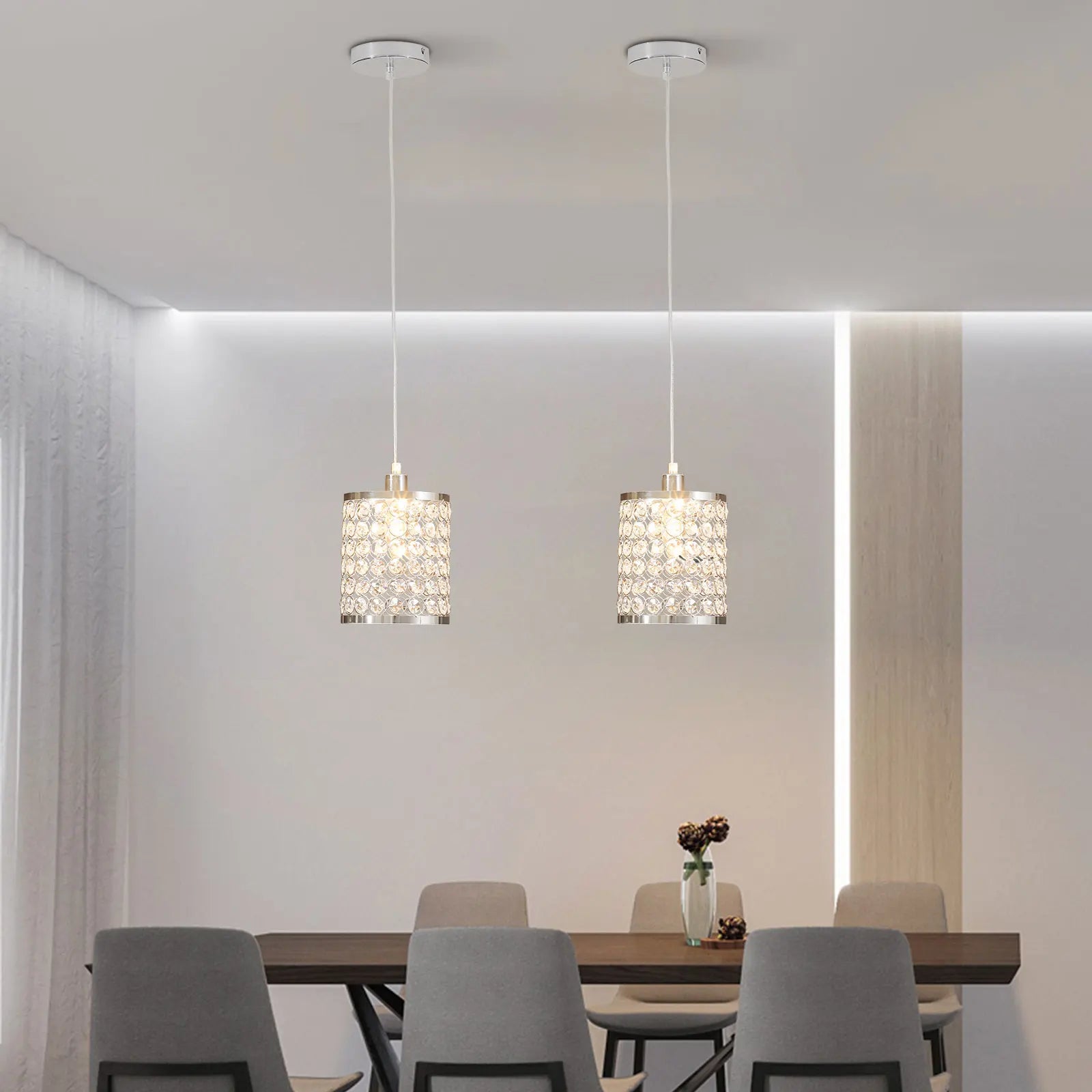 Elegant crystal pendant light with adjustable cord, perfect for modern kitchen islands.