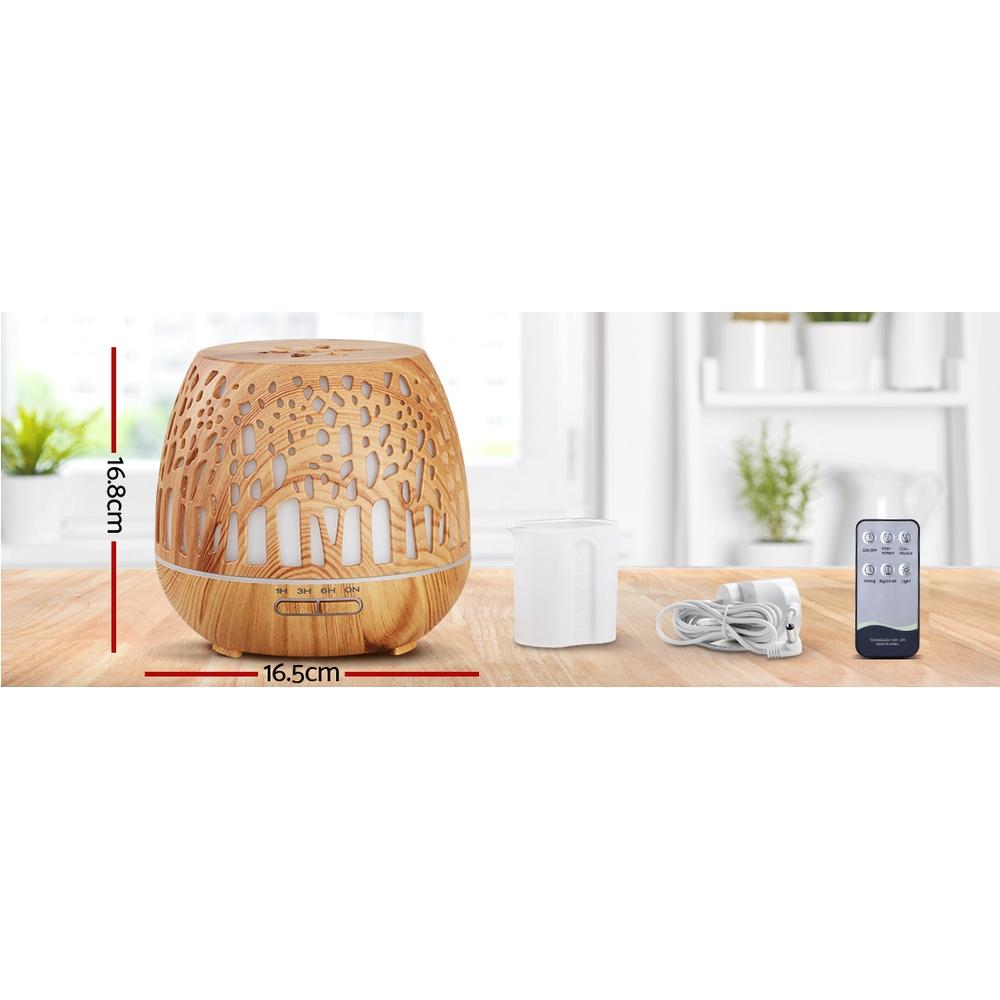 Devanti Aroma Diffuser with woodgrain finish and enchanted forest pattern, showcasing its sleek design and LED light features.