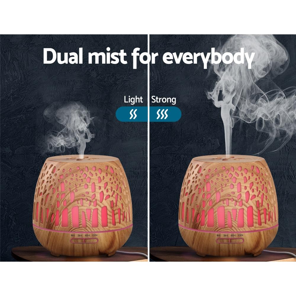 Devanti Aroma Diffuser with woodgrain finish and enchanted forest pattern, showcasing its sleek design and LED light features.