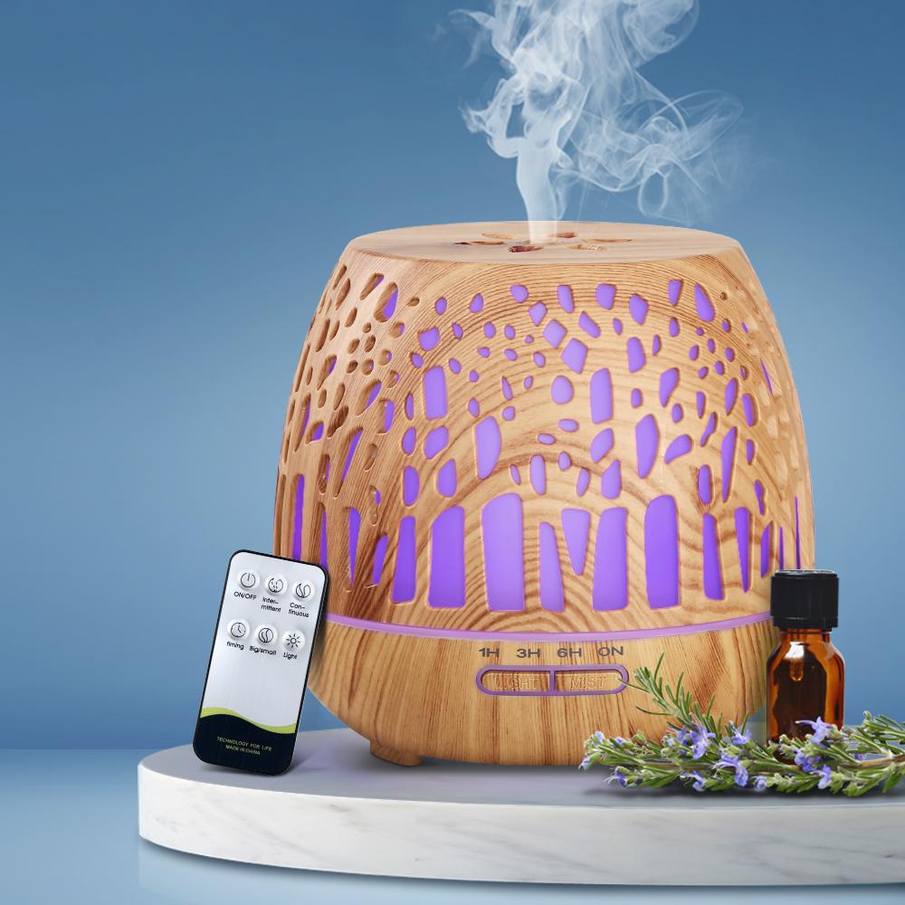Devanti Aroma Diffuser with woodgrain finish and enchanted forest pattern, showcasing its sleek design and LED light features.