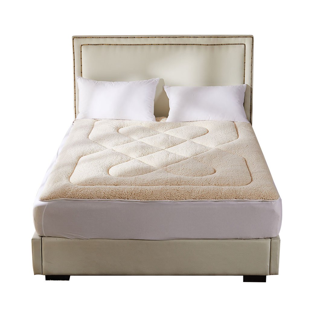 Dreamz Mattress Topper featuring 100% wool fleece and cotton, reversible design, cream and white color, with a fitted elastic skirt.