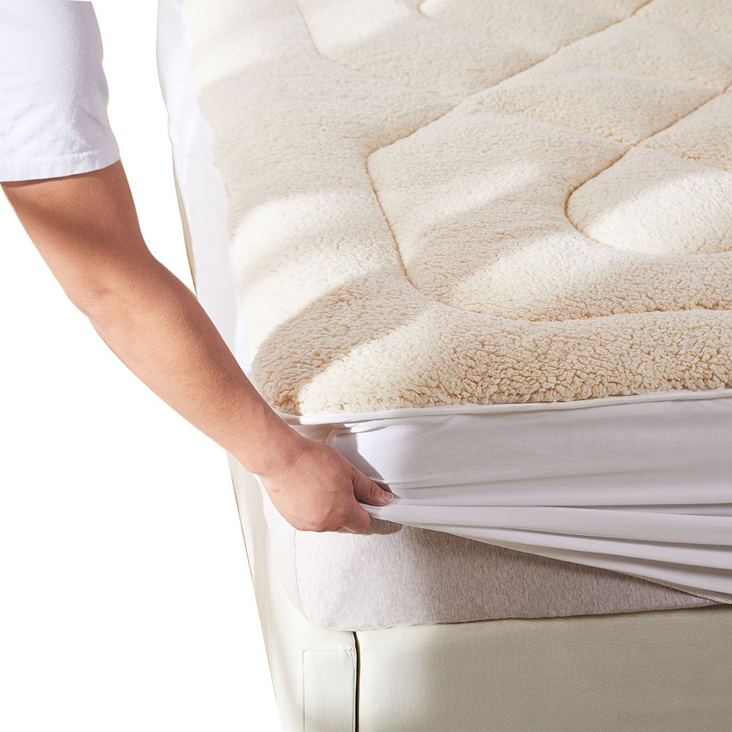 Dreamz Mattress Topper featuring 100% wool fleece and cotton, reversible design, cream and white color, with a fitted elastic skirt.